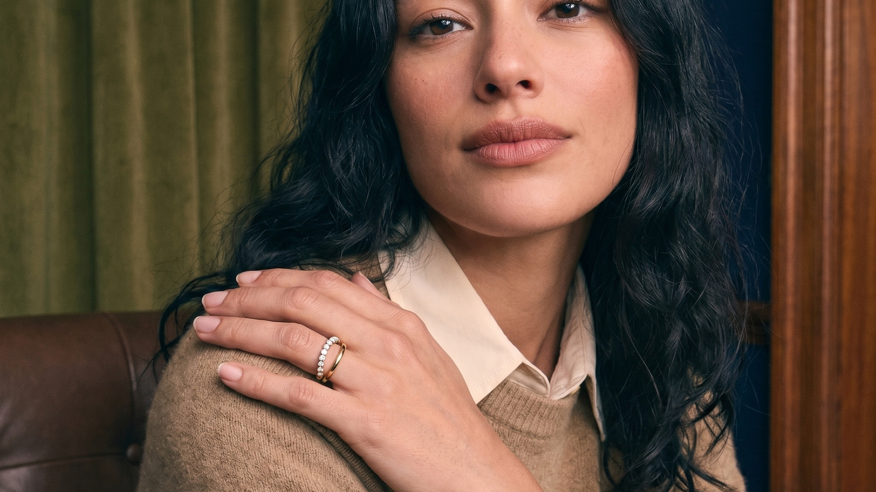 Curated ring stack of slim solid gold diamond bands worn on the hand, ring stacking styled in natural light