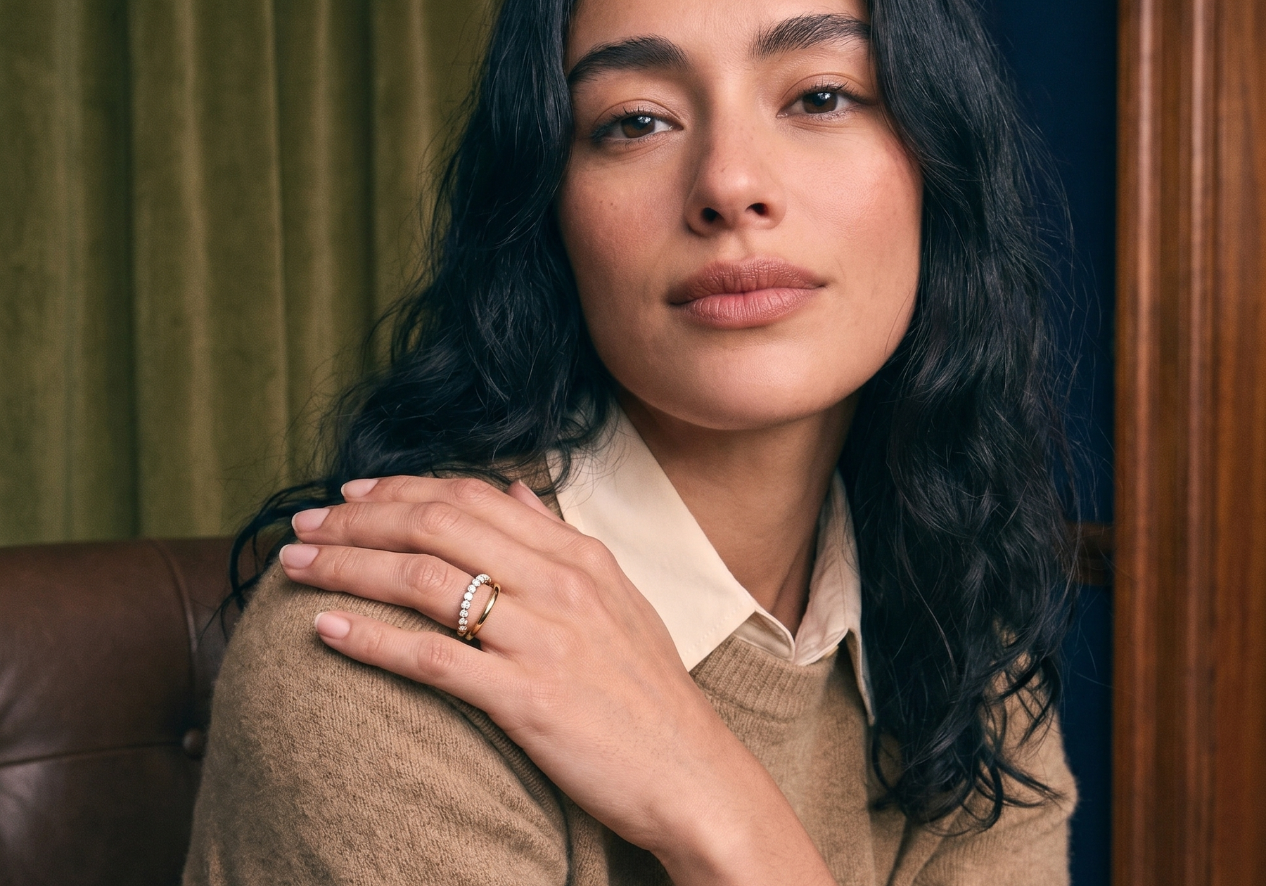 Curated ring stack of slim solid gold diamond bands worn on the hand, ring stacking styled in natural light