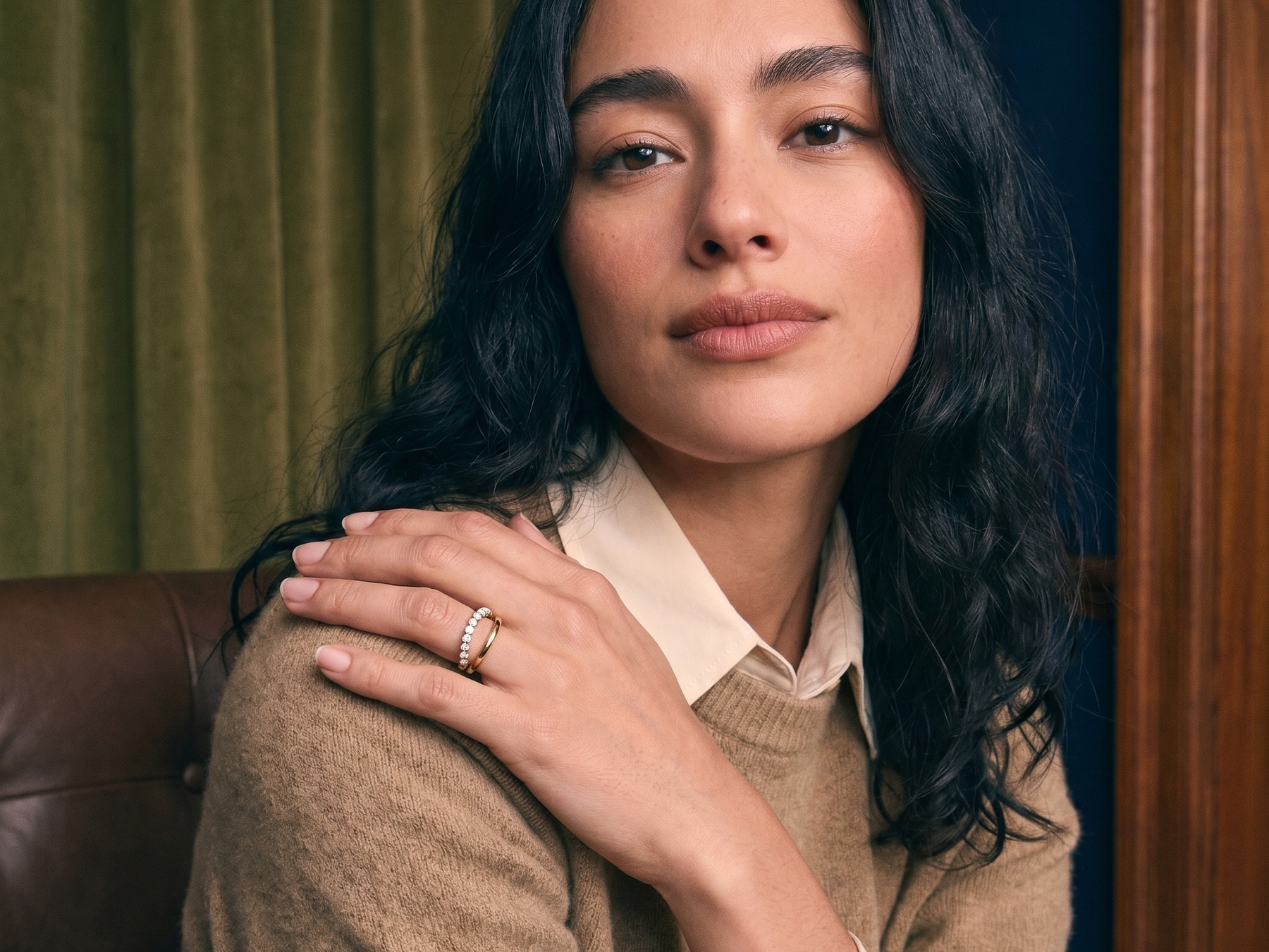 Curated ring stack of slim solid gold diamond bands worn on the hand, ring stacking styled in natural light