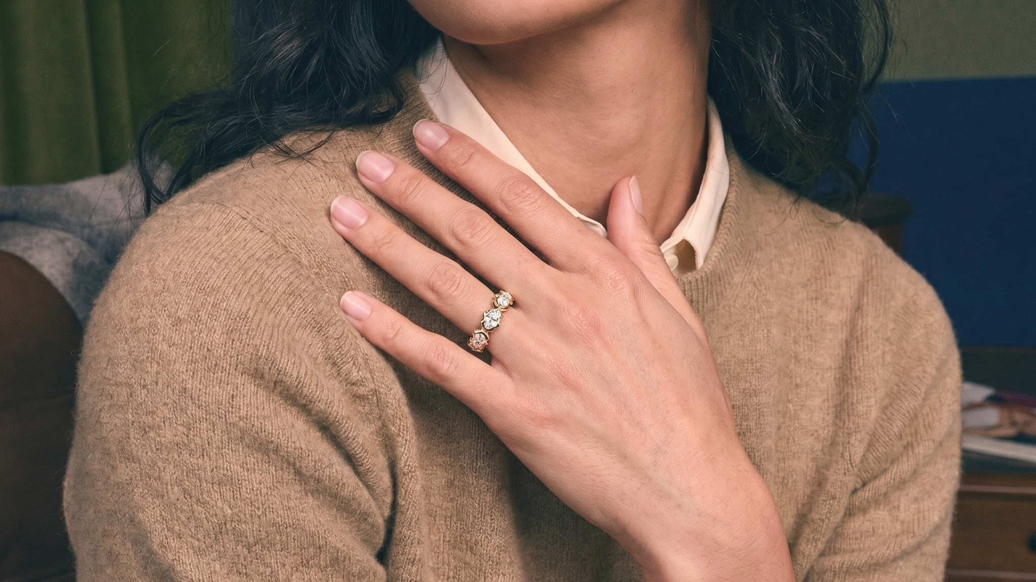 Diamond wedding band stacked on a woman's hand in solid gold, natural light