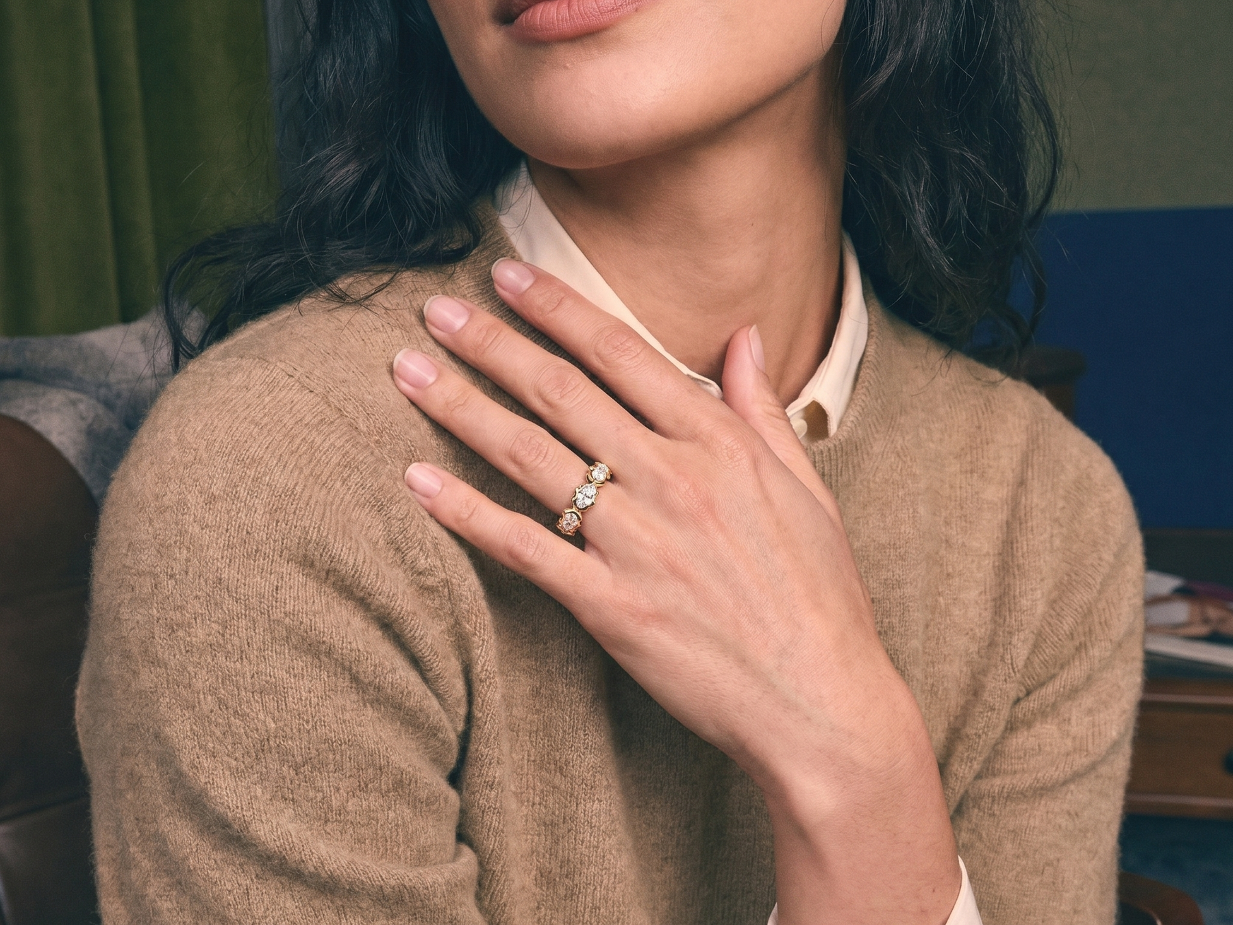 Hand wearing an east-west set marquise lab grown diamond ring in warm natural light