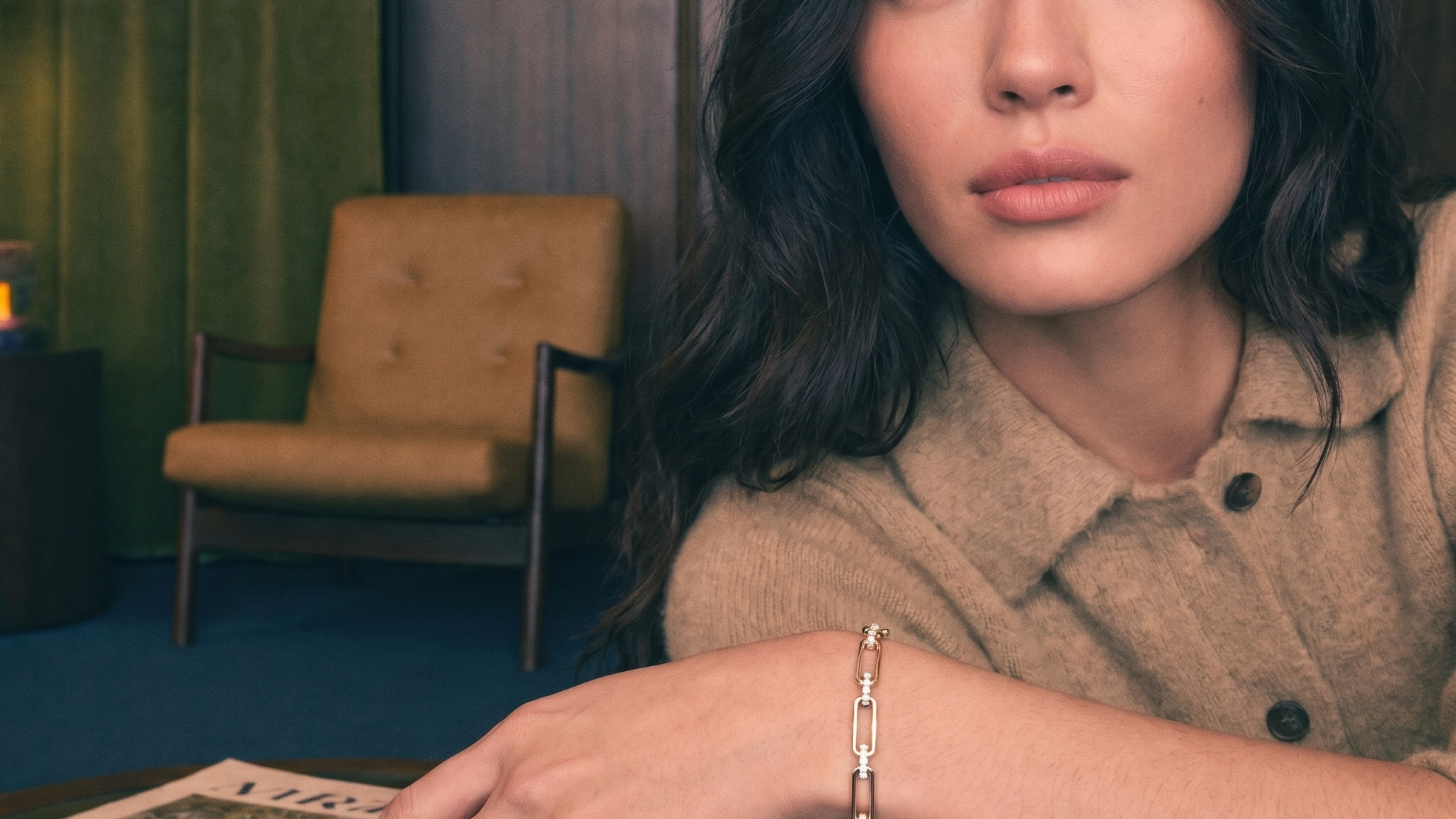 Round brilliant cut diamond tennis bracelet worn on the wrist in warm natural light