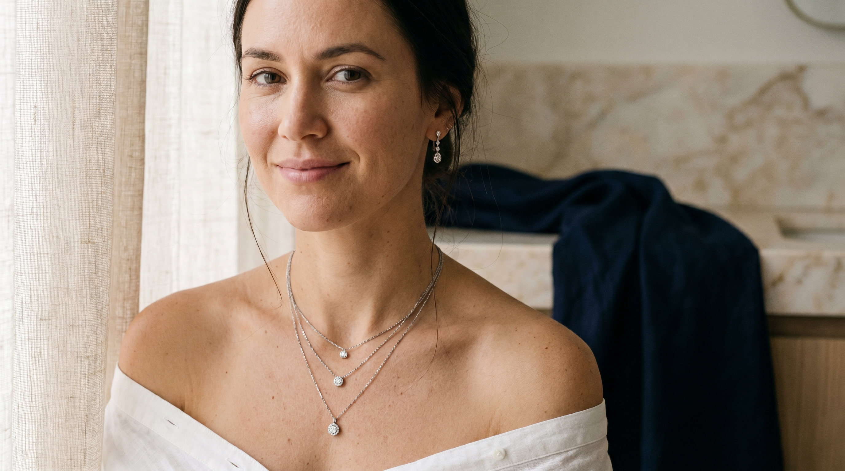Woman layering lab grown diamond necklaces and earrings for summer styling