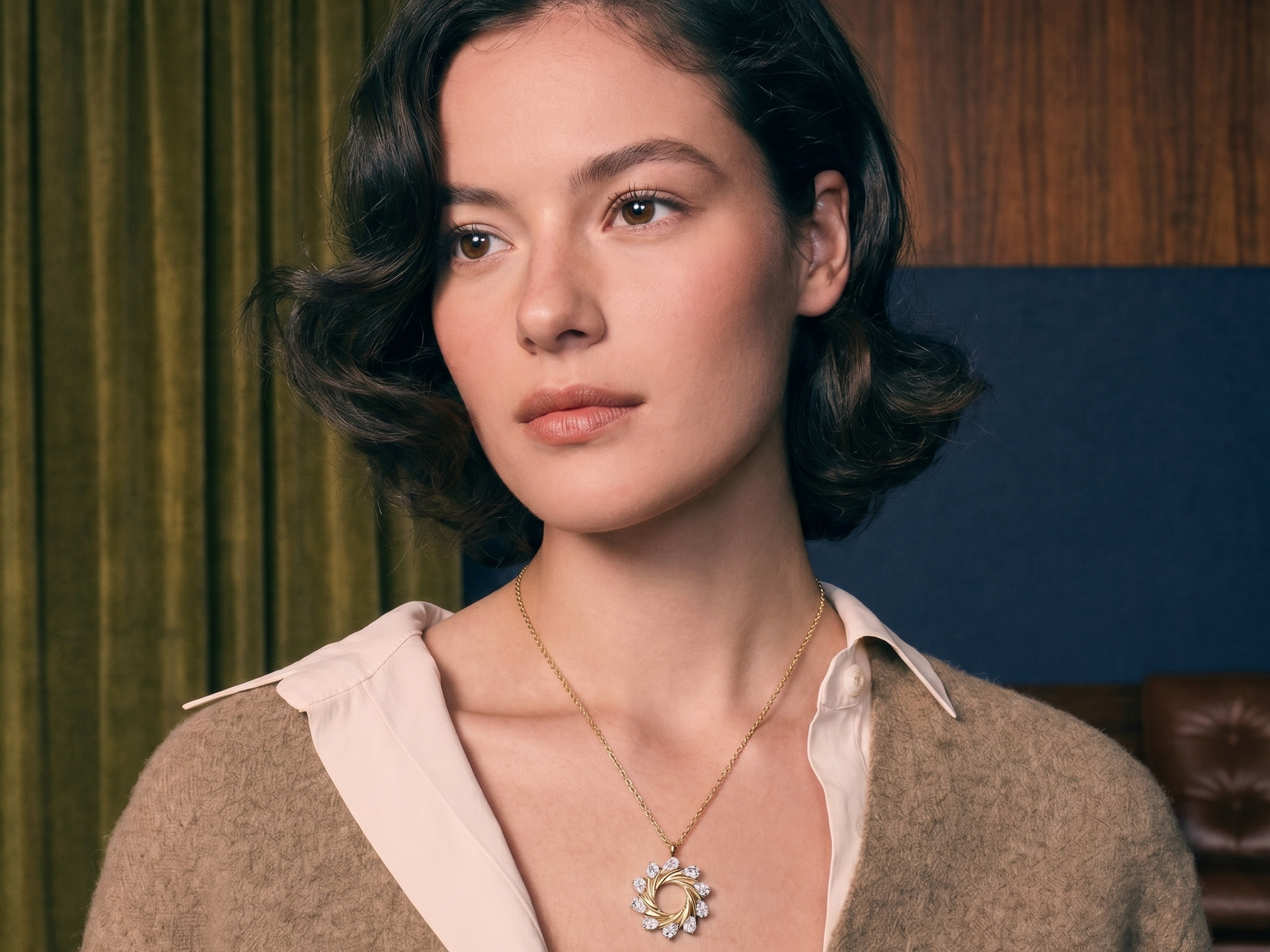 Custom diamond necklace and solitaire pendant in solid gold worn on the collarbone in natural light